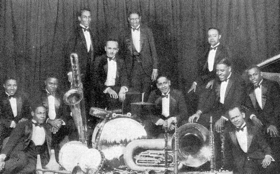 Fletcher Henderson's orchestra posed with instruments; a tuba lies front centre